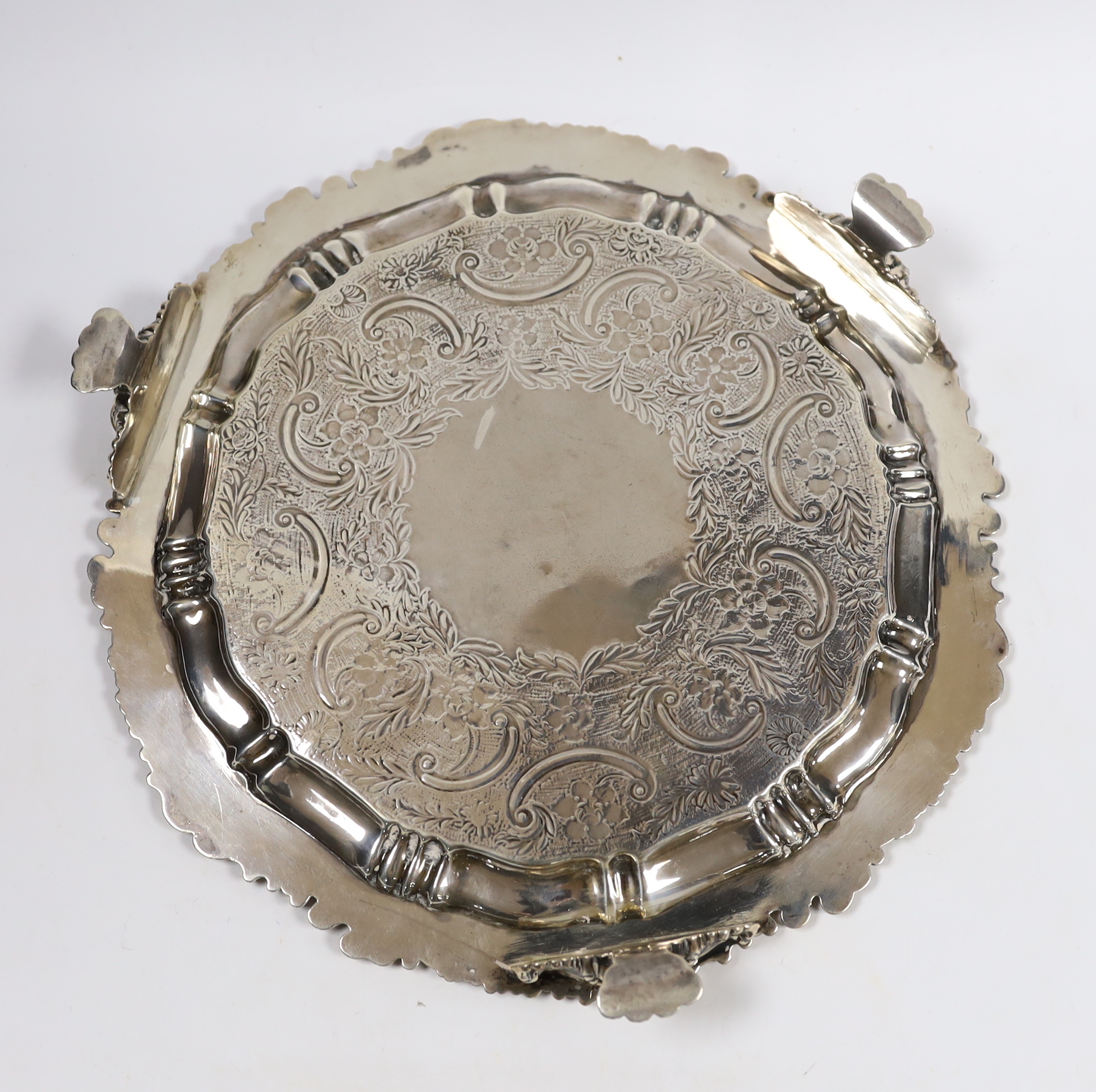 An early 19th century engraved silver salver, marks rubbed, 30.8cm, 26oz.